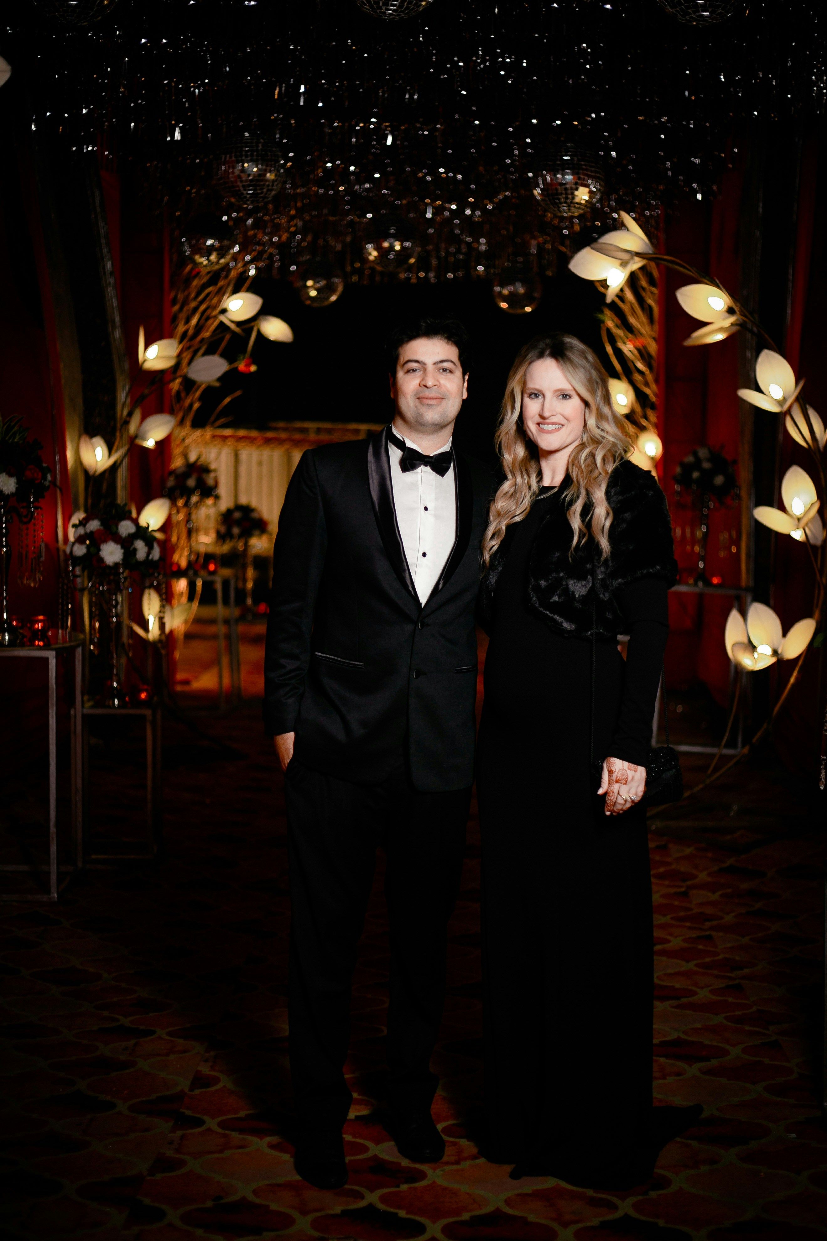 Sophisticated charity gala setup with round tables, ambient lighting, and a performance area for Broadway karaoke entertainment